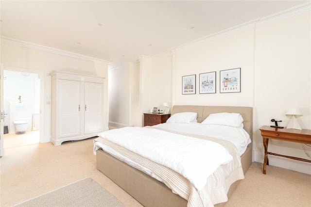 The principal bedroom has a walk-in dressing area and a refitted en suite shower room