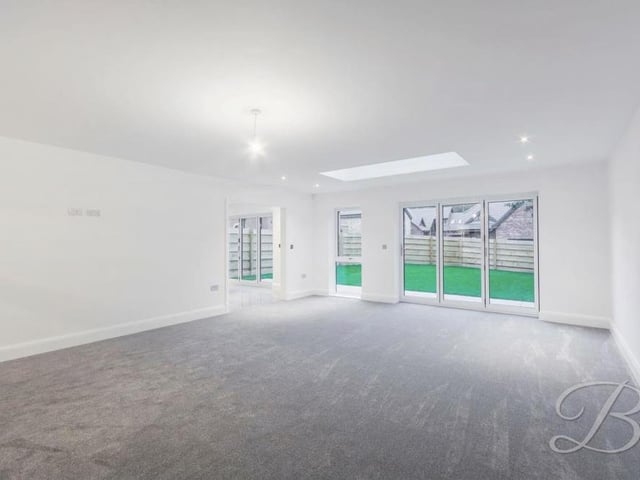 Next to the kitchen sits this large and bright lounge. It wouldn't be hard to put your personal stamp on this lovely room. Again, doors lead to the garden at the back.