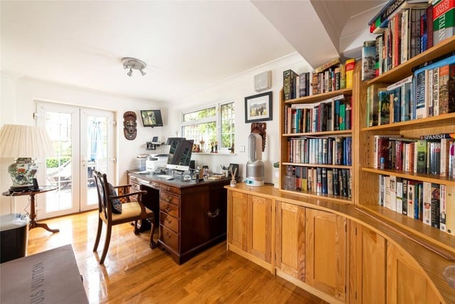The study - measuring 15ft 6in by 7ft 11in - has a range of bespoke furniture and also glazed doors to the rear garden