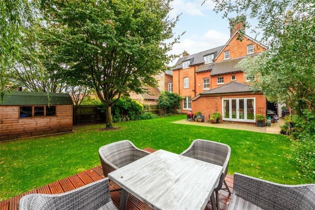 A gate provides access to the rear garden which is fully enclosed by a combination of walling and timber fencing and is screened by mature trees and trellis to the rear. It has a block paved terrace and a raised decked outdoor entertaining area