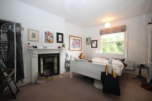 This room measures 15ft 2in by 11ft 11in and features a cast iron fireplace with tiled hearth