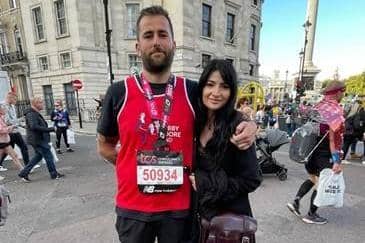 Sean Howard with his medal and girlfriend Megan Malster after the London Marathon
