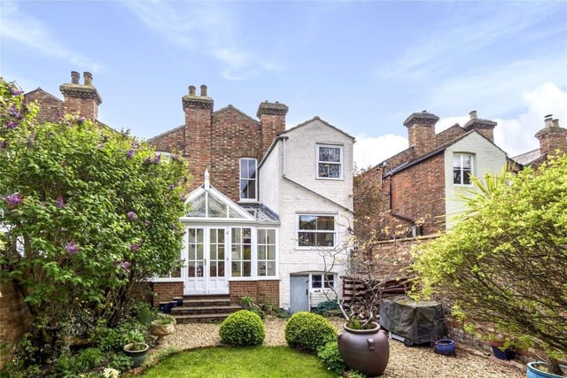 A driveway at the side of the property provides access to the neighbouring property and has a gate into the rear garden which is a major feature and is enclosed fully by high brick walling. There is a timber shed, log store, and an external door accessing a cellar