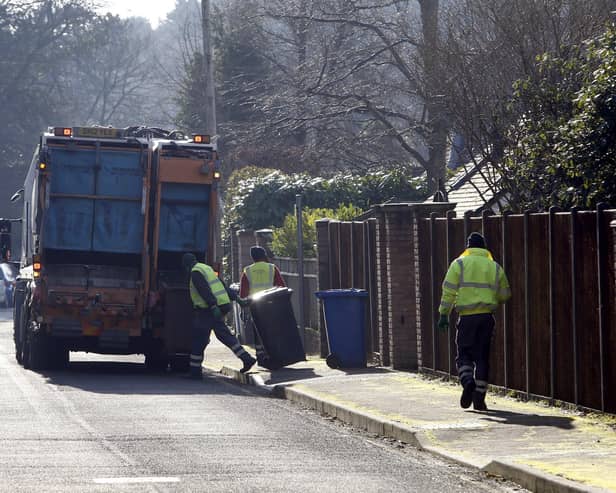 Council workers emptying bins (Picture: Steve Parsons/PA Wire)