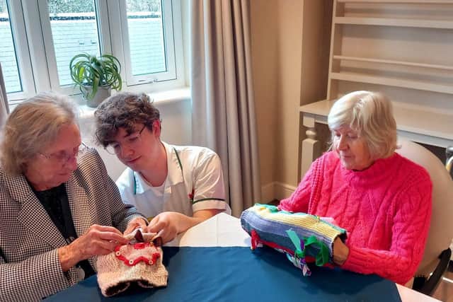 Student Luca bought in a bag of dementia fiddle blankets that his grandmother had made for residents.