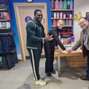 Athlete and TV personality Harry Aikines-Aryeetey applauds as general manager Gemma Garner-Higgins and Cllr Gareth Mackey cut Flitwick Leisure Centre's 10th birthday cake