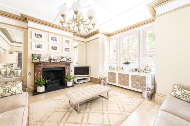 This room has a shuttered bay fronted window and a feature marble fireplace
