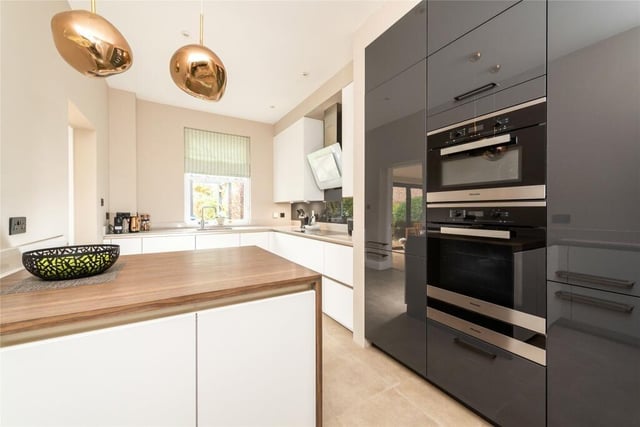The kitchen was refitted in 2016 in a range of contemporary style cabinets by Siematic with quartz and hardwood work surfaces incorporating a sink with a boiling water tap. Integrated Miele appliances include an electric oven with warming drawer and a microwave