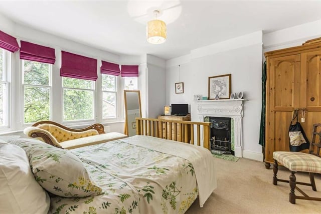This large double bedroom boasts a fireplace, sash windows and picture rails