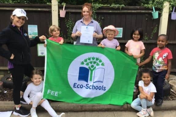 Kiddi Caru Day Nursery and Preschool in Bedford with its Eco-School Green accreditation flag certificate