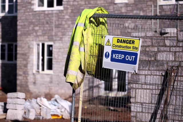 A labourer's jacket hangs on a fence at a housing construction  (Photo by Matt Cardy/Getty Images)