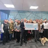 The team Assure Consulting Ltd hand over £5,000 to healthcare charity Sue Ryder