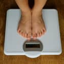 File shot of a young child on the scales