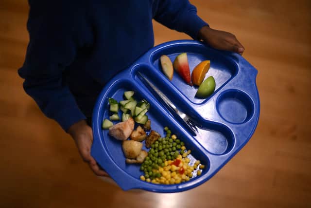 A child carries a tray with food. Picture: Getty Images