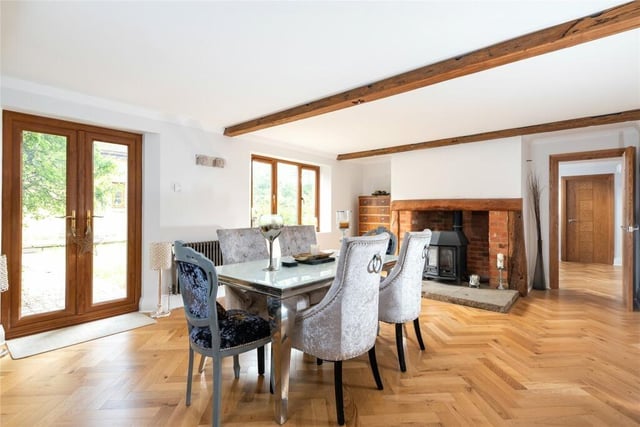 This room is dual aspect and has exposed ceiling beams, an inglenook style fireplace with raised flagstone hearth and inset log burning stove. Glazed double doors lead to the rear garden