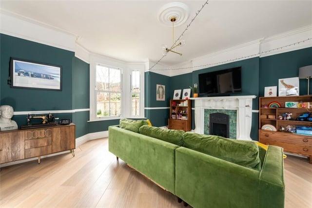 The family room, at the rear of the house, has a bay window, a feature fireplace and Karndean flooring