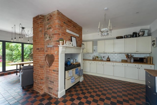 The kitchen features Shaker-style painted furniture and a Belfast sink as well as space for American-style fridge/freezer