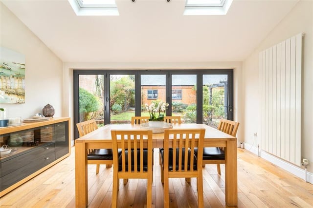 This room is in a single storey part vaulted extension with inset remotely operated Velux windows and bi-fold doors to the rear garden. Both this room and the sitting room have an air conditioning unit