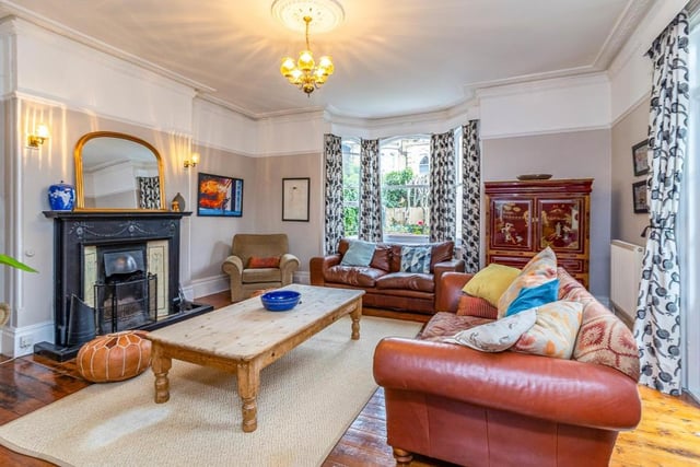 This room has a feature fire surround with hand-carved decorative mouldings, original Victorian wooden flooring and original casement single glazed double doors leading to a single glazed conservatory