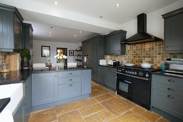 The cupboards are a classy dark grey with black granite worktops