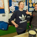 Two Scouts cooking a pancake on a camping stove.