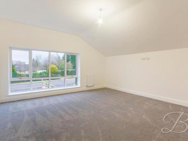 The master bedroom is full of natural light, thanks to wide windows overlooking the front of the £800,000 property. It boasts en suite facilities.