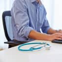 Close up of doctor In office working at computer
