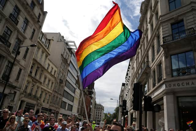 A rainbow flag is held aloft at the Pride in London parade