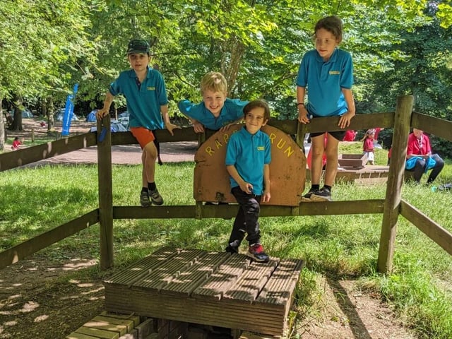 Beaver Scouts stand above an underground tunnel entrance
