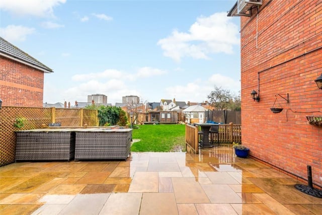 Steps lead down from a raised Indian sandstone terrace to the enclosed rear garden which is principally lawned. Another paved area at the rear has a koi pond. There is a home office with sliding doors, power, internet, heating and air conditioning and a brick and uPVC summerhouse