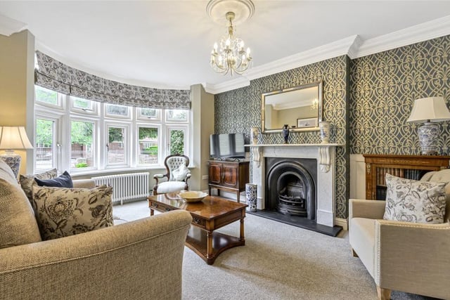 The sitting room has a bay window to the front, deep moulded covings, part panelled walls and a traditional marble and cast iron fireplace with an inset Living Flame gas fire
