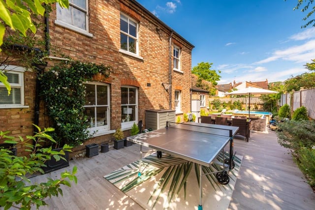 The landscaped rear garden has an extensive porcelain tiled outdoor entertaining area which has a step leading down on to the main garden