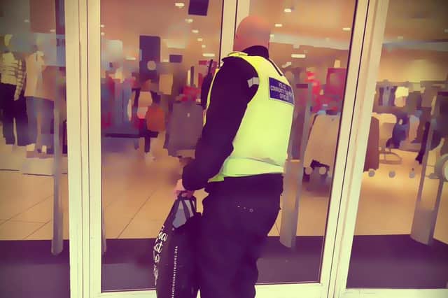 An officer with the stolen goods from New Look, in Midland Road, Bedford (Picture: Bedford Community Policing Team)