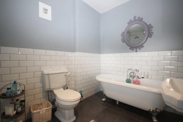 This room has a four-piece suite comprising free standing four claw bath with mixer shower, low level wc, pedestal wash hand basin, double shower, and sash window to the rear