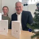 Thea and Richard Fuller, MP with winning Christmas Card