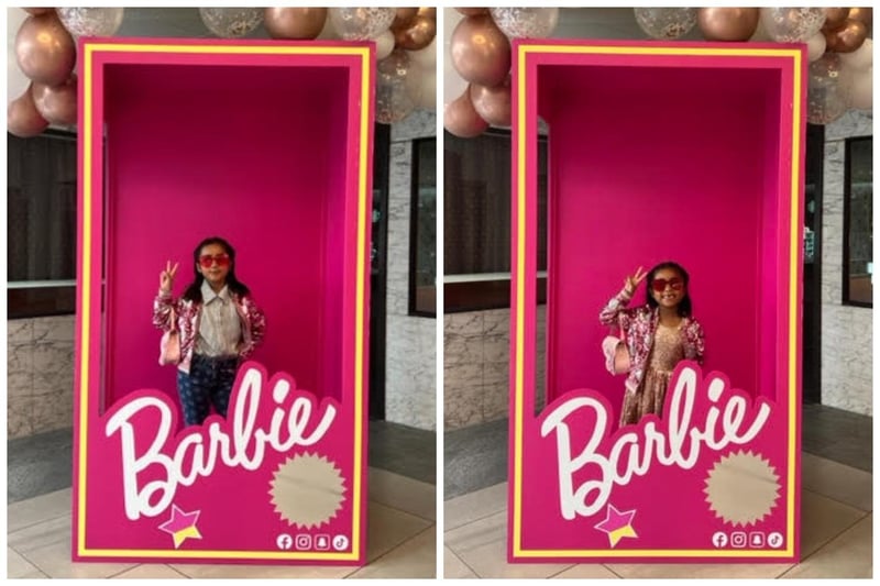 Peace signs while posing in the Barbie box