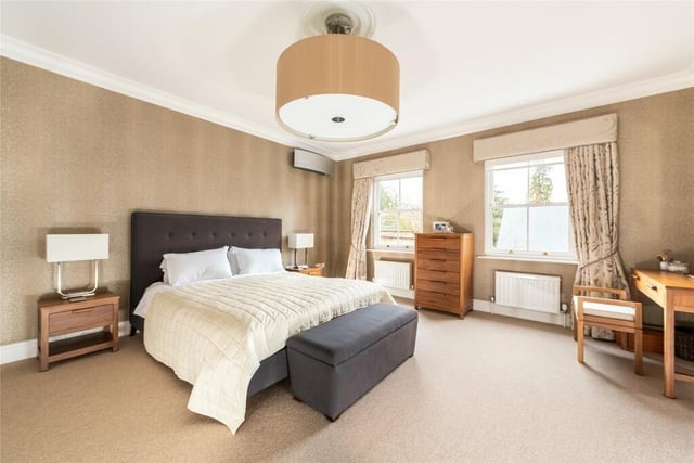 The master bedroom has an en suite, a dressing room and a range of custom-built wardrobes