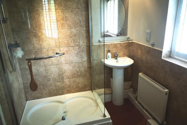 The stylish family bathroom has a four-piece suite with separate shower cubicle.