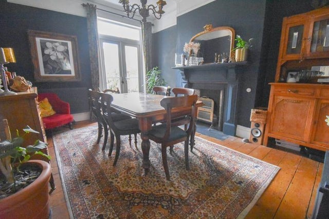 The separate dining room - which also features an open fireplace - measures 14ft 9in by 11ft 5in