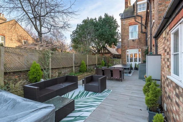 There's a large wrap-around terrace with an extensive porcelain-tiled entertaining space