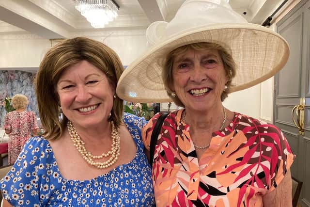 Captivating in cream - retired Lord Lieutenant Helen Nellis poses with one guest who clearly loves the stylish number she's wearing
