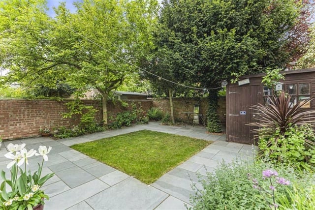 The pretty rear garden is walled all around and patio is laid around a small lawn. The secluded patio to the rear of the second living room is a lovely addition and mature trees screen the garden nicely from neighbouring properties