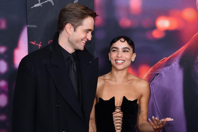 Lead actors Robert Pattinson and Zoe Kravitz share a joke on the red carpet (Photo by ANGELA  WEISS / AFP) (Photo by ANGELA  WEISS/AFP via Getty Images)