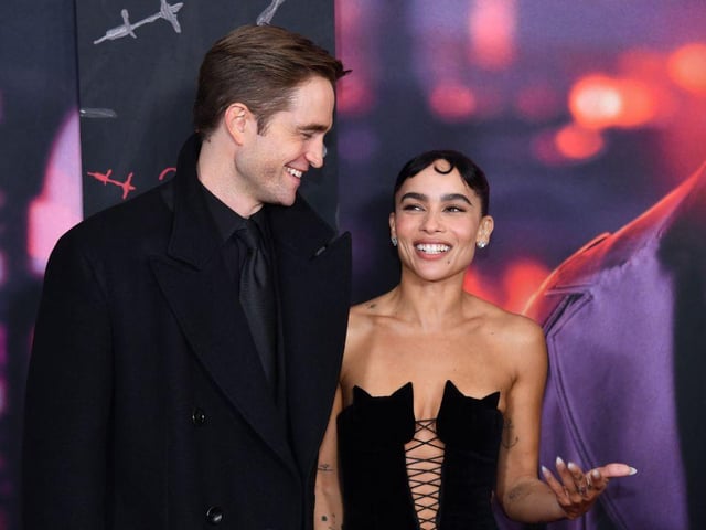 Lead actors Robert Pattinson and Zoe Kravitz share a joke on the red carpet (Photo by ANGELA  WEISS / AFP) (Photo by ANGELA  WEISS/AFP via Getty Images)