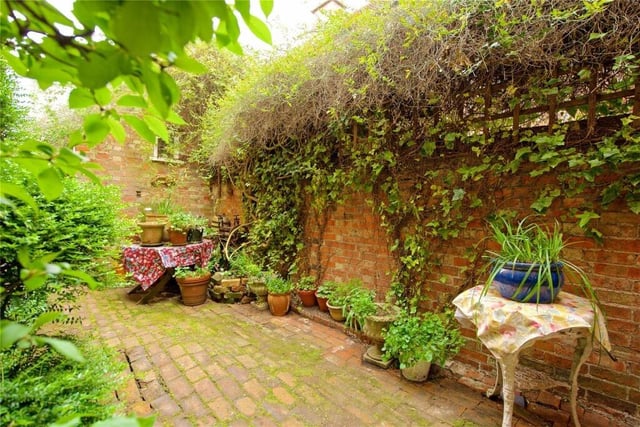 The rear garden is a major feature of the property and includes an original brick pathway and shaped paved outdoor entertaining area