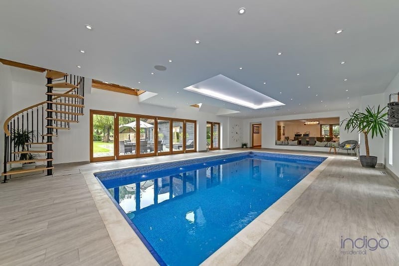 The indoor heated pool includes French doors and bi-folding doors leading on to the rear patio. It features a shower room/changing room