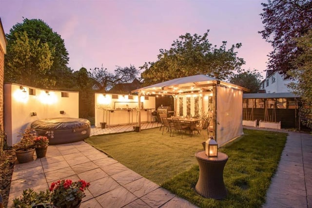 A central pergola allows for al fresco living. There are also two garages and a capacious shed for additional storage
