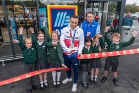 Olympic medalist Ryan Owens cutting the ribbon to the new Aldi store with help from students from The Firs Lower Primary School. Picture: Tim George