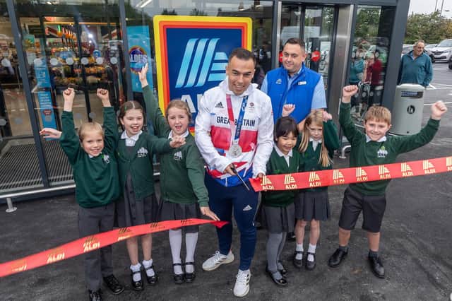 Olympic medalist Ryan Owens cutting the ribbon to the new Aldi store with help from students from The Firs Lower Primary School. Picture: Tim George