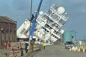 A ship is currently leaning towards the docks at a worrying angle in Leith, Edinburgh. (Photo credit: @Tomafc83 on Twitter)